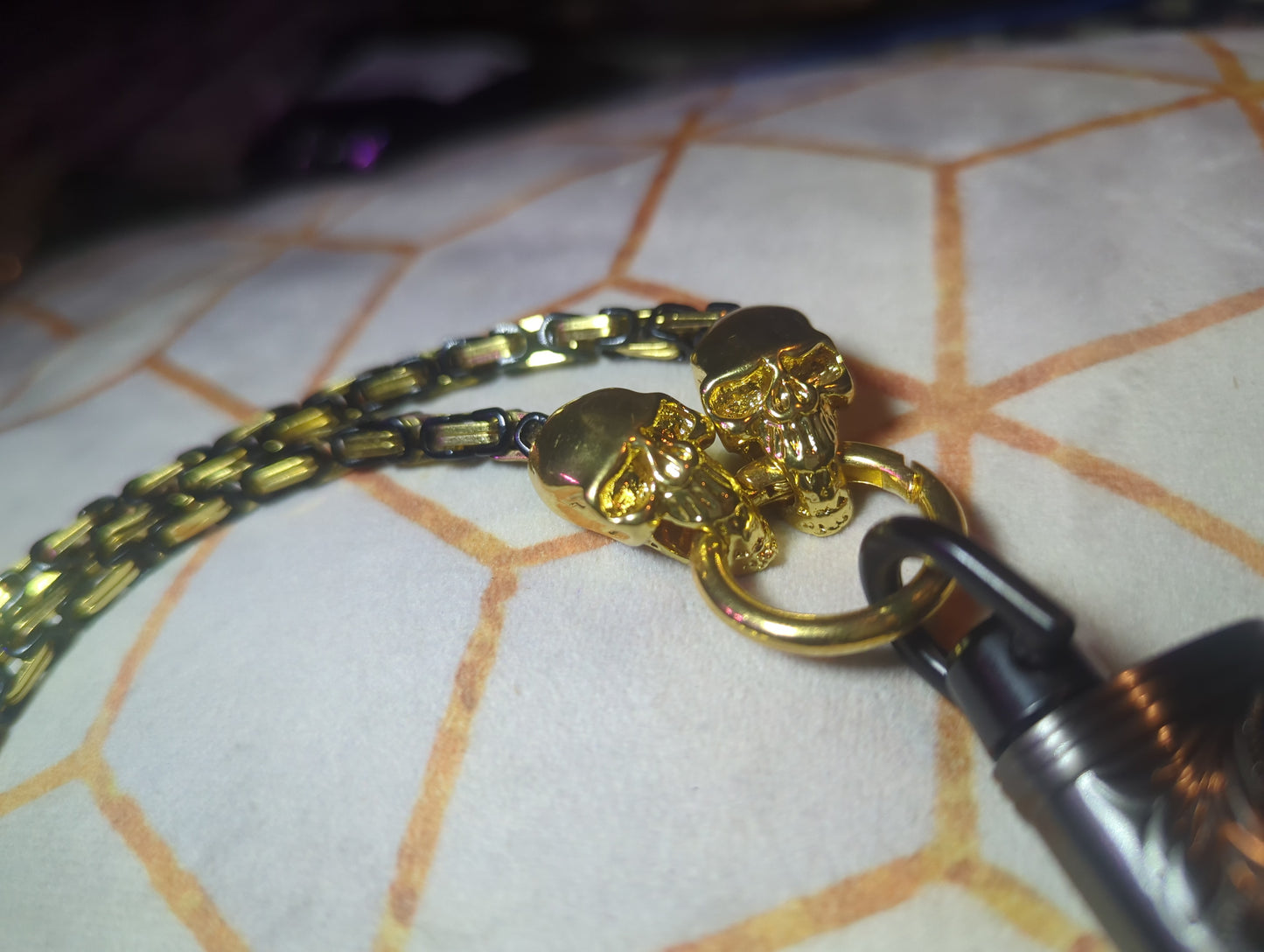 Black and gold chain with gold skull embellishments